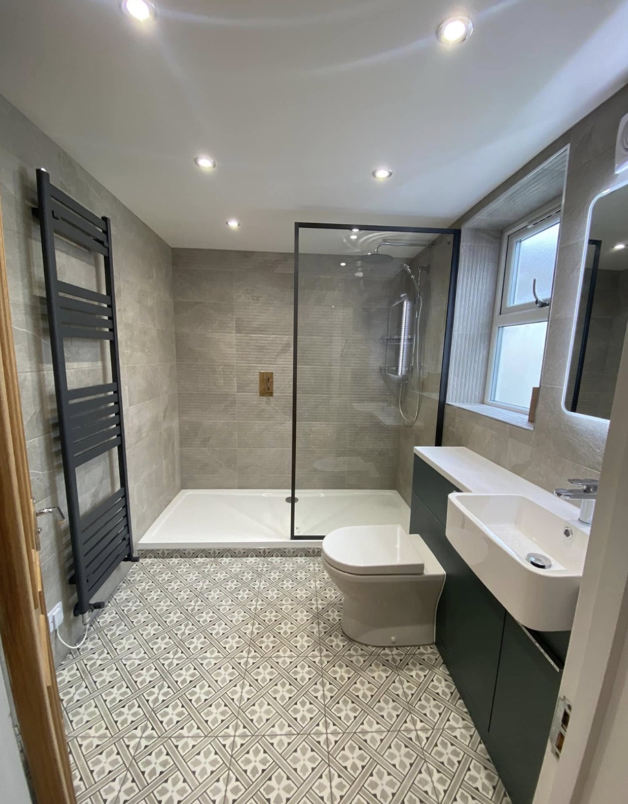 Finished bathroom with downlights and illuminated mirror