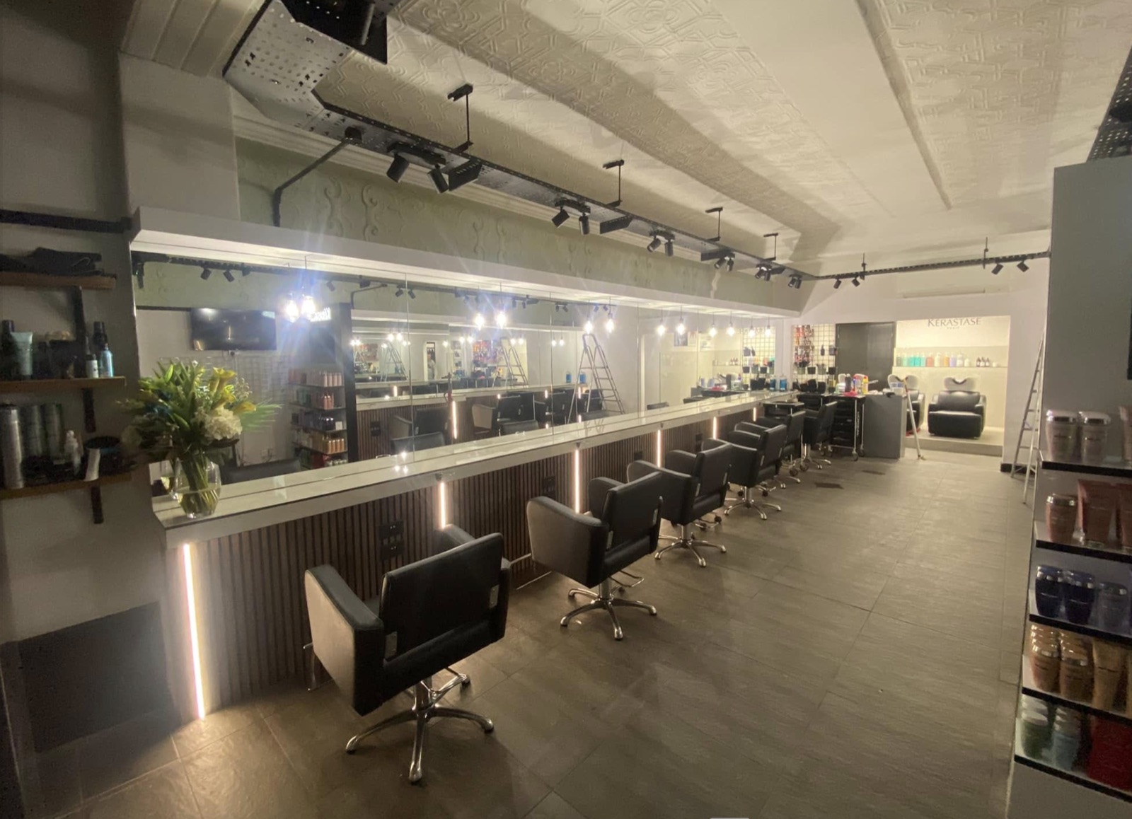 Salon interior with track lighting and illuminated mirrors