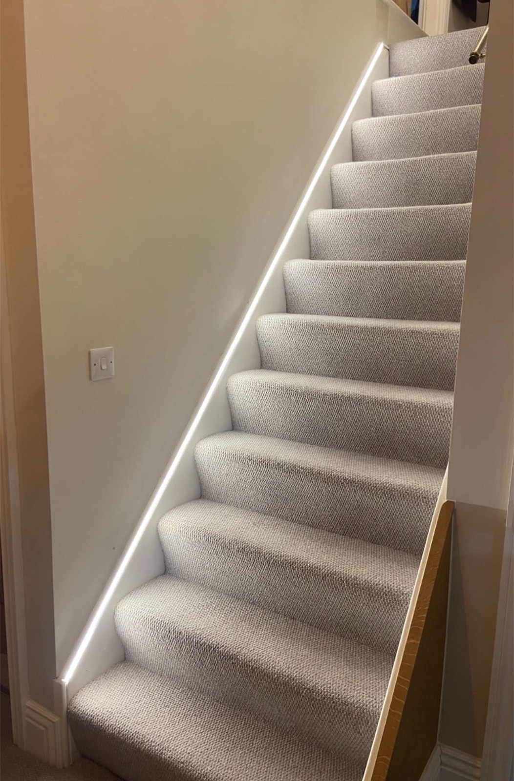 LED strip lighting run along a staircase stringer